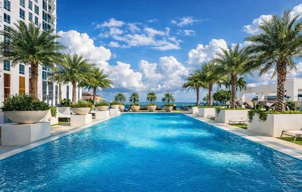 a swimming pool with outdoor seating