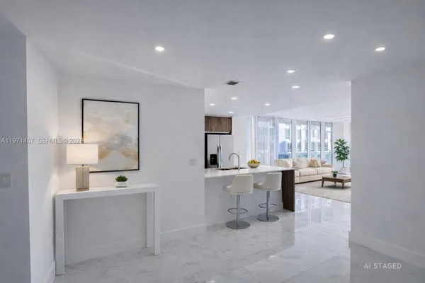 a large white kitchen with a large window