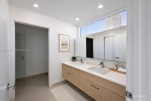 a bathroom with a double vanity sink and mirror