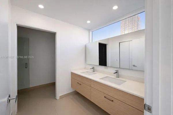 a bathroom with a double vanity sink and mirror