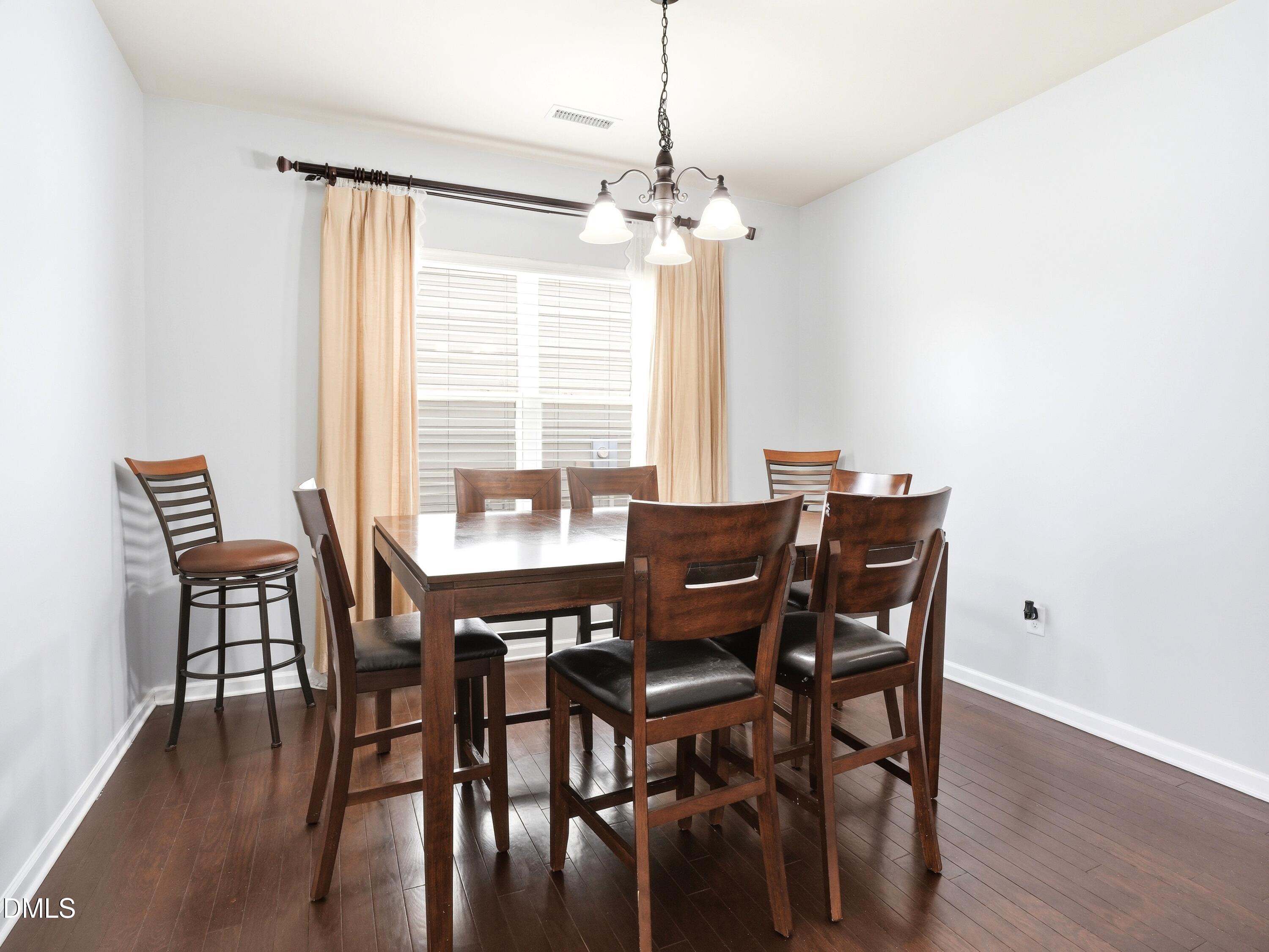 8128 Hovingham Way Raleigh, NC 27616 - Photo 12 of 40 a view of a dining room with furniture window and outside view