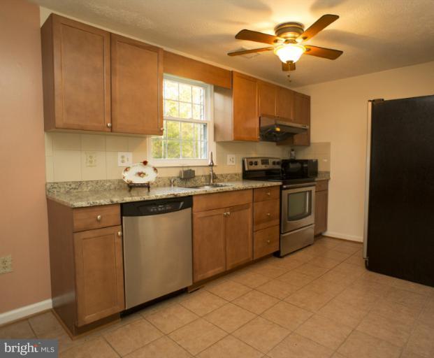 6224 Hillside Road Springfield, VA 22152 - Photo 2 of 8 a kitchen with stainless steel appliances granite countertop a stove a sink dishwasher and a refrigerator