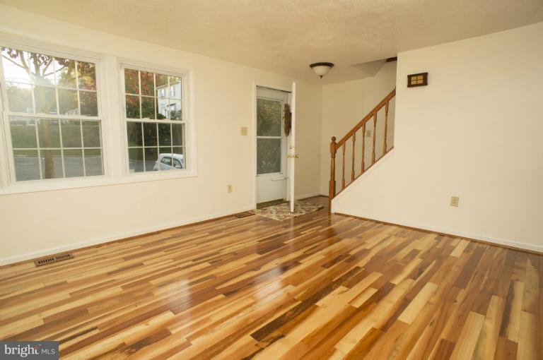 6224 Hillside Road Springfield, VA 22152 - Photo 4 of 8 a view of an empty room with wooden floor and a window