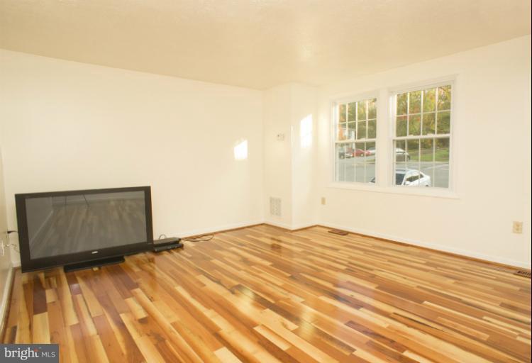 6224 Hillside Road Springfield, VA 22152 - Photo 5 of 8 a view of an empty room with wooden floor and a window