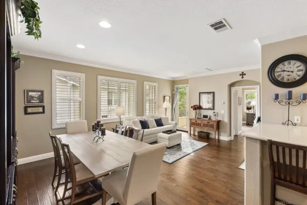 a view of a a dining room with furniture window and wooden floor