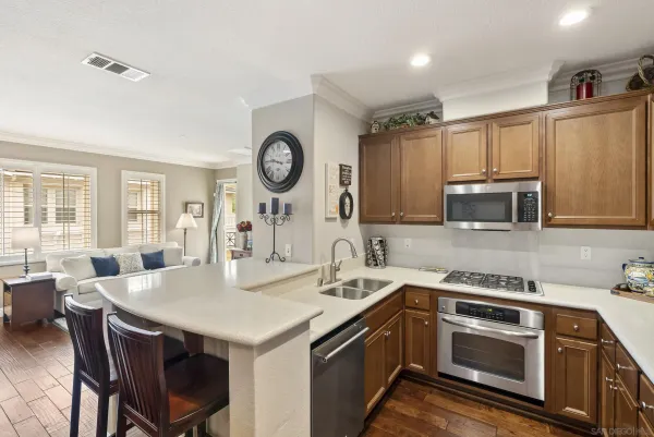 a view of a kitchen with a sink and living room
