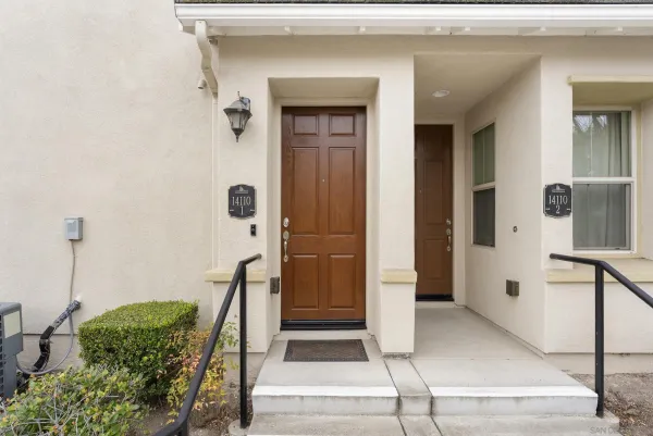 a view of staircase with lots of frames on wall