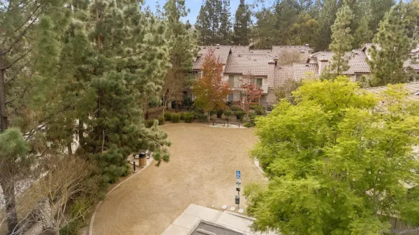 a view of backyard with swimming pool and seating