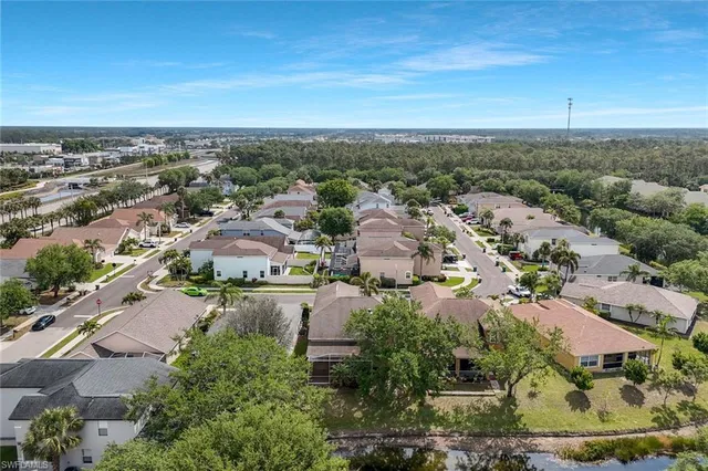 a aerial view of a house with a yard and large tree