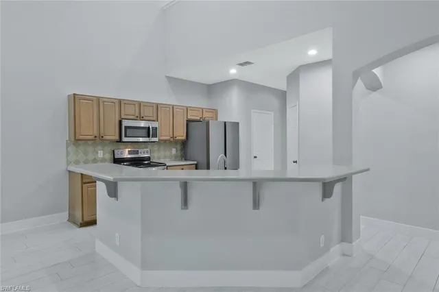 a view of kitchen with microwave and cabinets