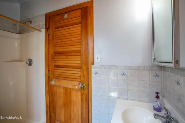 a view of a livingroom with wooden floor and windows