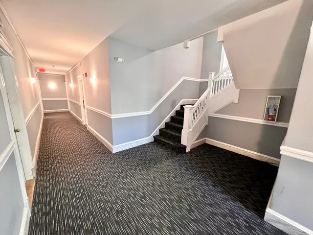 a view of entryway with wooden floor and stairs