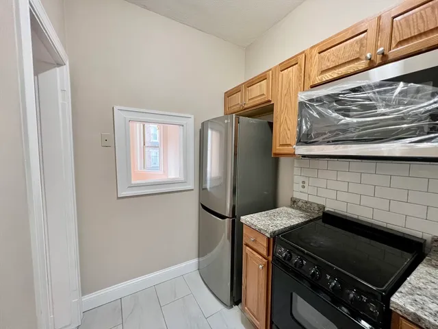 a kitchen with a stove and a refrigerator