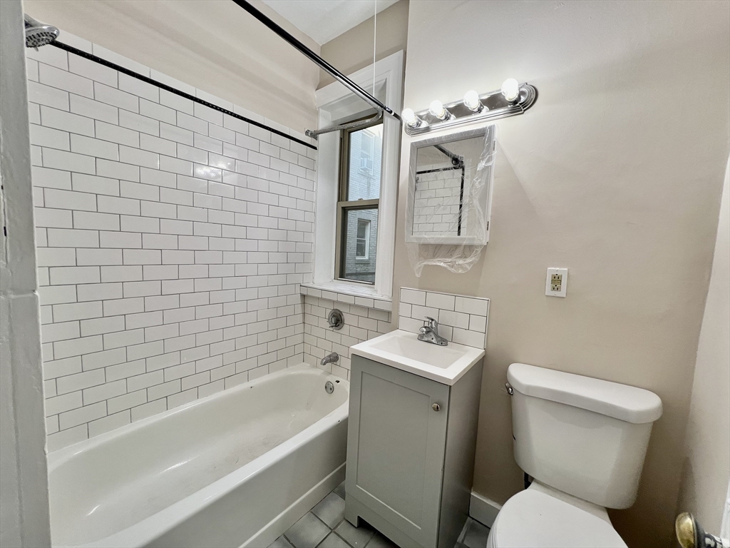 1669 Commonwealth Avenue, Unit 3 Boston, MA 02135 - Photo 9 of 10 a bathroom with a toilet sink and bathtub