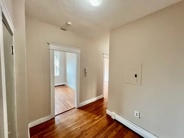 a view of an empty room and wooden floor