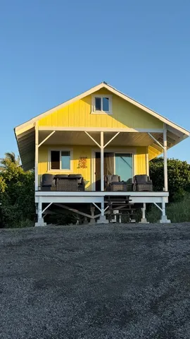 a front view of house with car parked