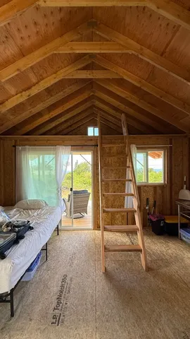 a bedroom with furniture and large windows