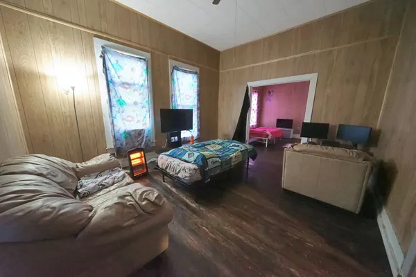a bedroom with furniture and a wooden floor