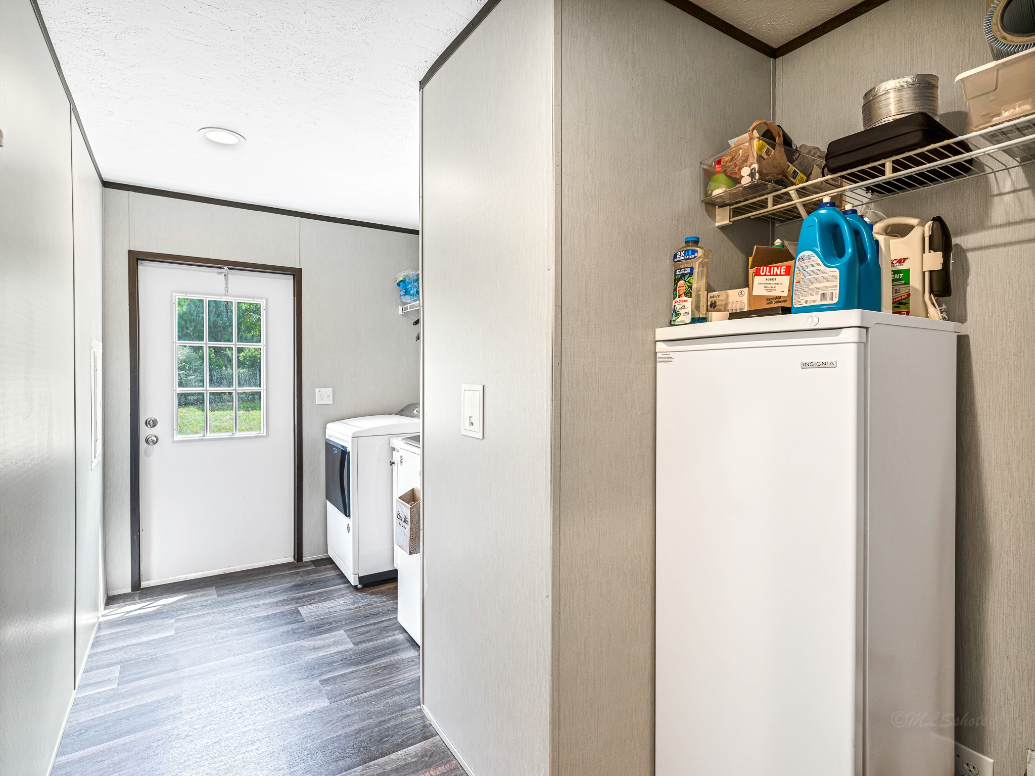 1047 Jimbob Lane New Ulm, TX 78950 - Photo 13 of 18 Large utility room provides plenty of space. Insignia Upright Freezer STAYS with the house! The back door takes you outdoors to your clothes line, your vegetable garden or just the wide open space!