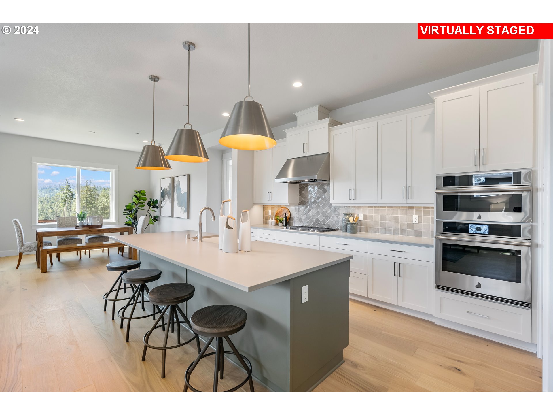 2784 North 49th Avenue Camas, WA 98607 - Photo 3 of 28 a kitchen with stainless steel appliances kitchen island a table chairs in it and wooden floors