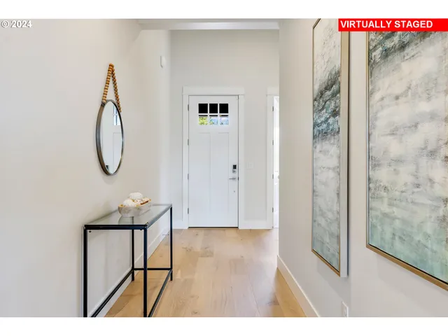 a picture of a room with wooden floor and mirror