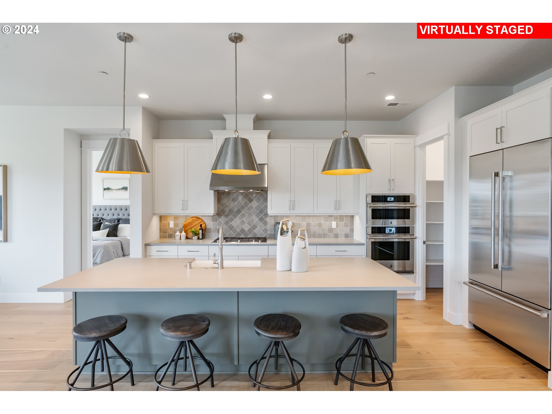 2784 North 49th Avenue Camas, WA 98607 - Photo 7 of 28 a kitchen with stainless steel appliances kitchen island granite countertop a table chairs sink and refrigerator