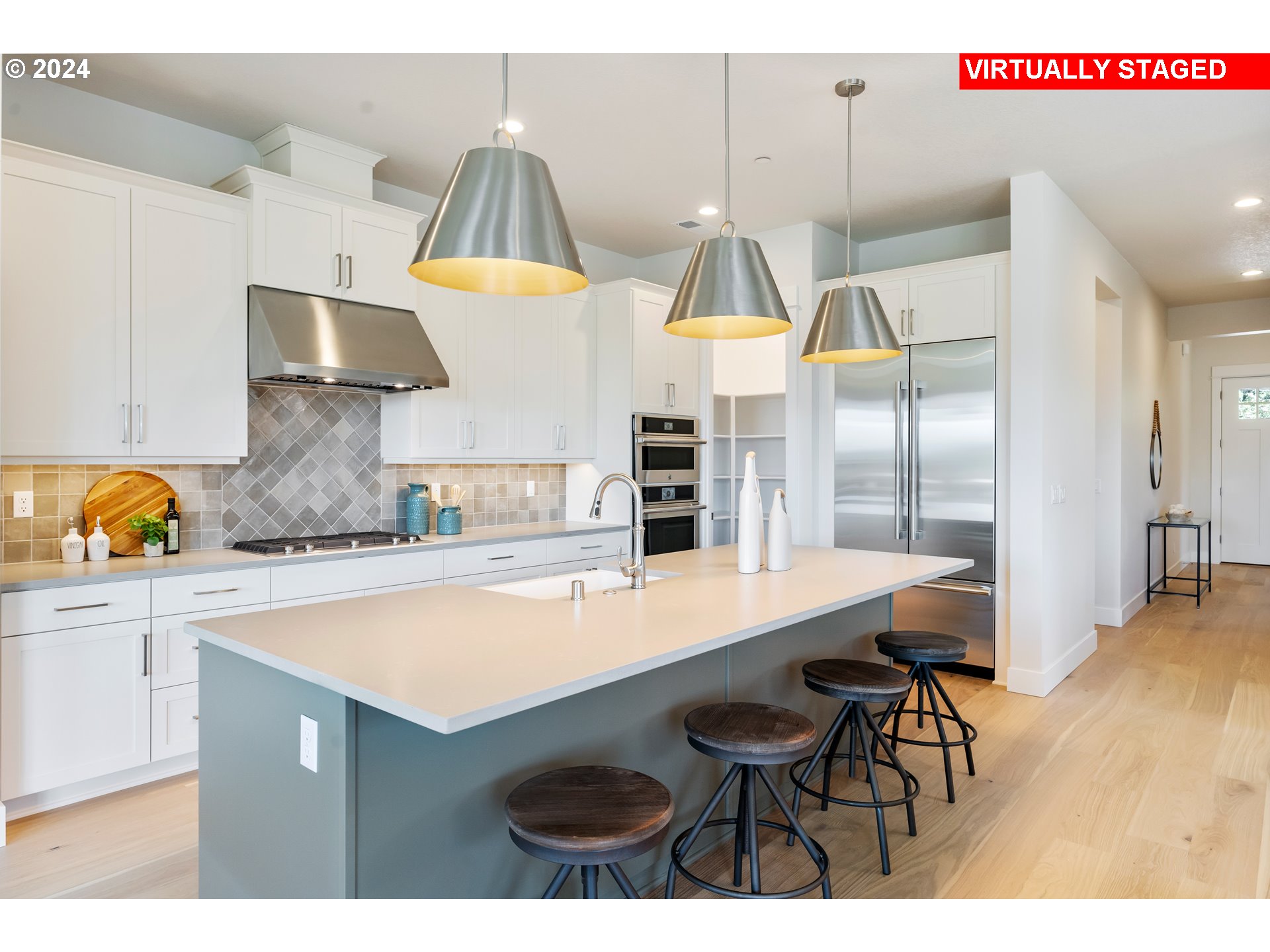 2784 North 49th Avenue Camas, WA 98607 - Photo 9 of 28 a kitchen with stainless steel appliances a sink a stove and white cabinets