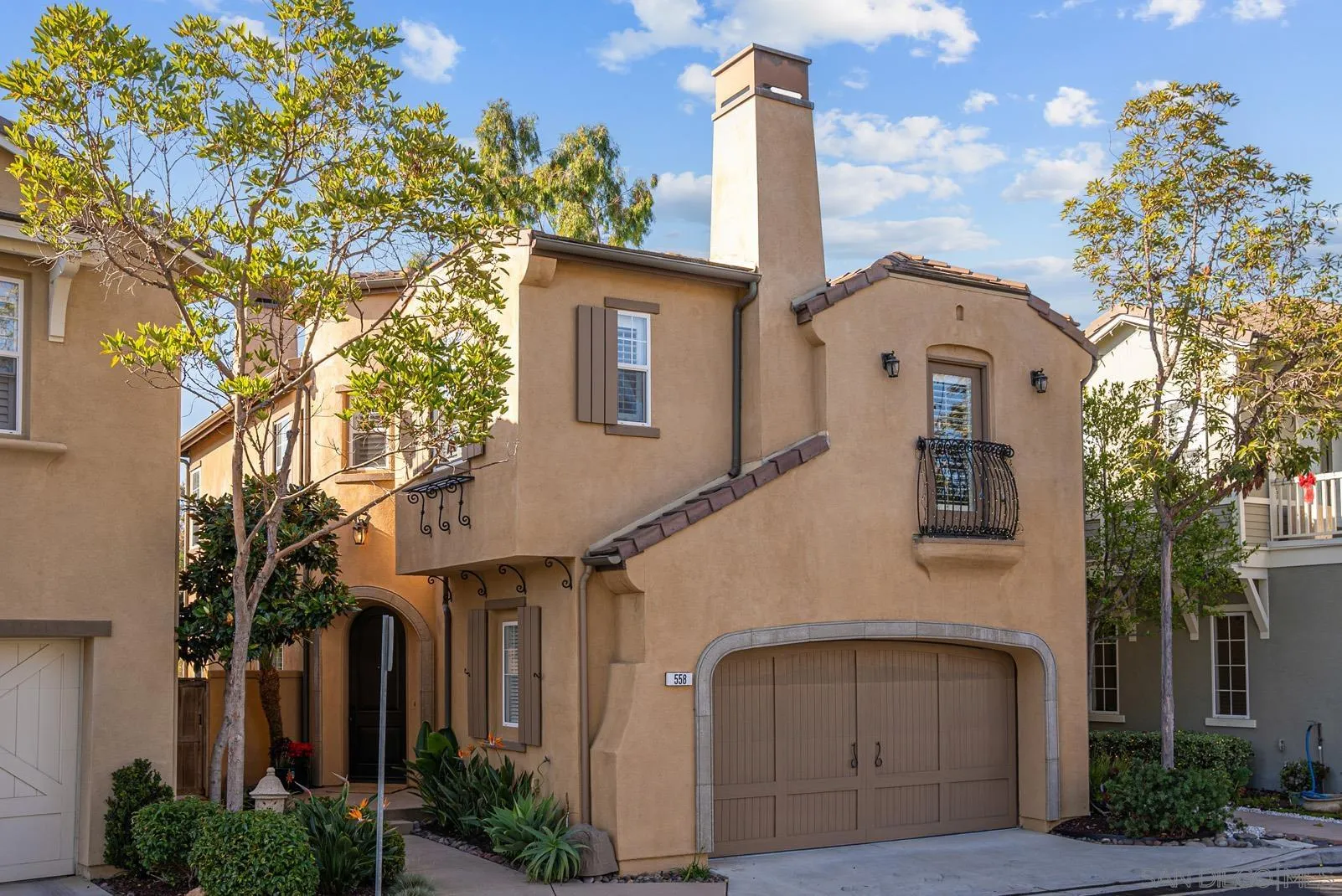 a front view of a house with a garden