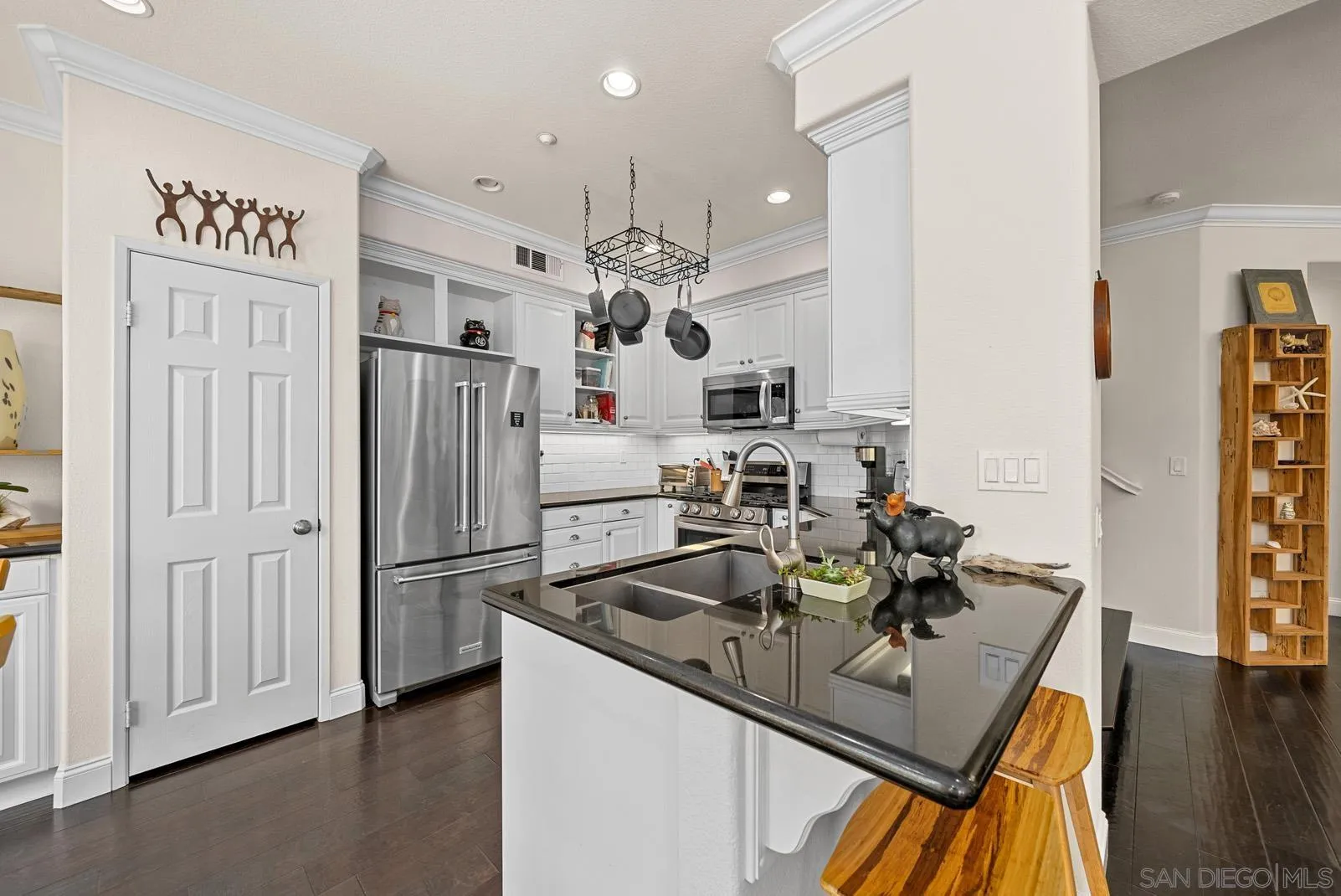 558 Beach Street Encinitas, CA 92024 - Photo 3 of 29 a kitchen with stainless steel appliances granite countertop a sink dishwasher stove and refrigerator with wooden floor