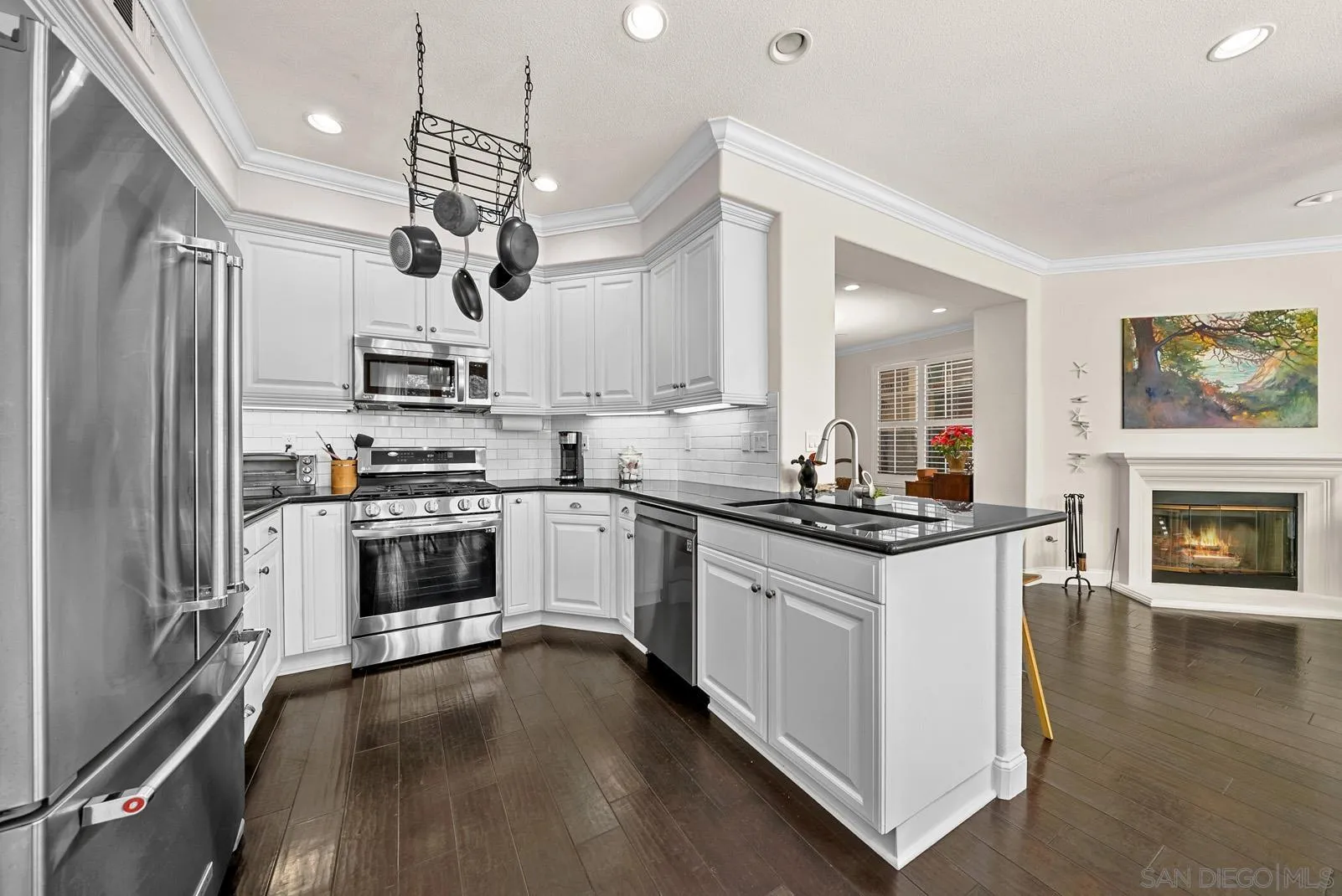 558 Beach Street Encinitas, CA 92024 - Photo 4 of 29 a kitchen with stainless steel appliances granite countertop a stove a sink dishwasher a refrigerator white cabinets and wooden floor
