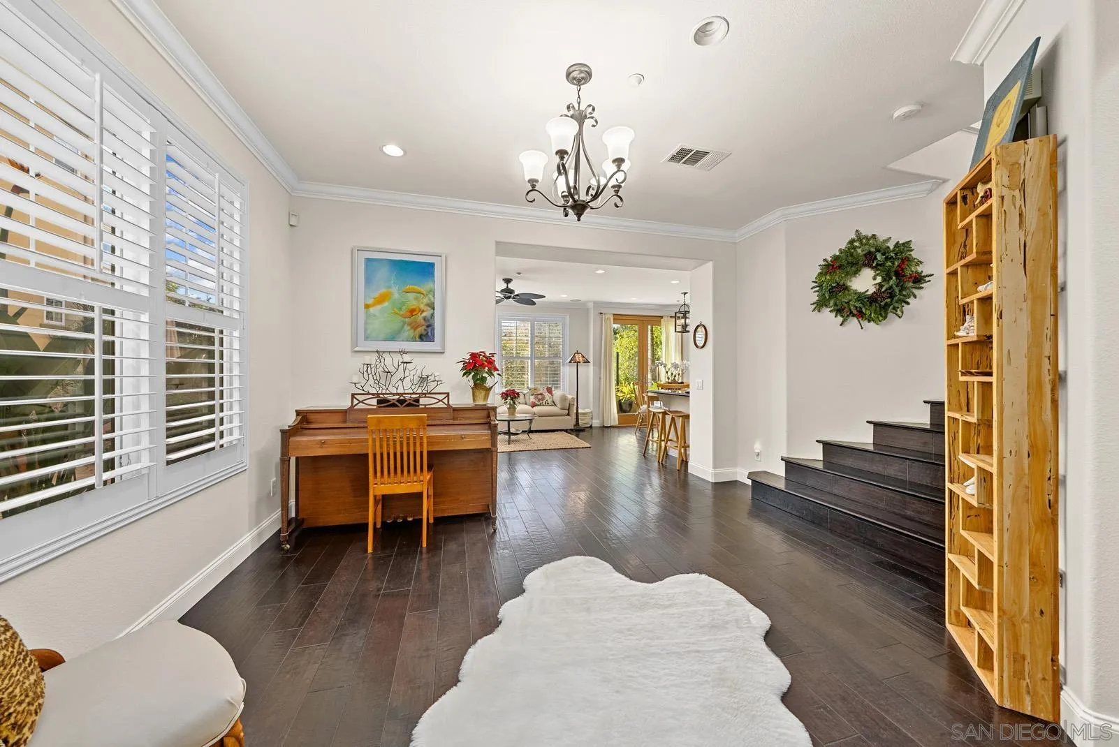 558 Beach Street Encinitas, CA 92024 - Photo 10 of 29 a dining room with wooden floor a chandelier a glass table and chairs