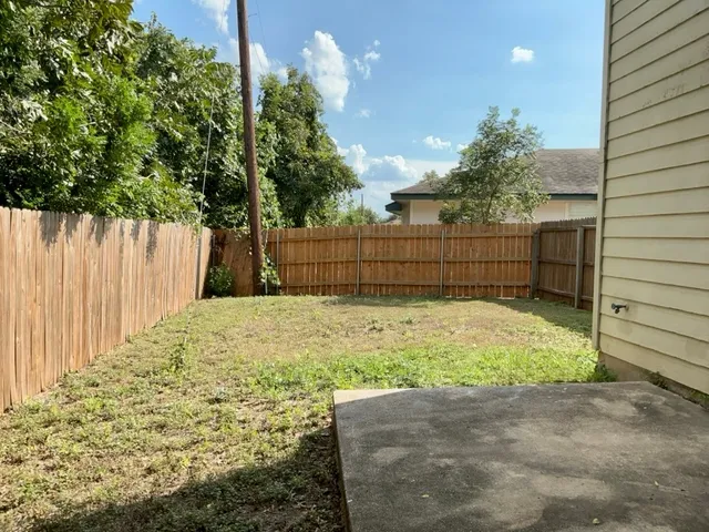 a view of a backyard of the house