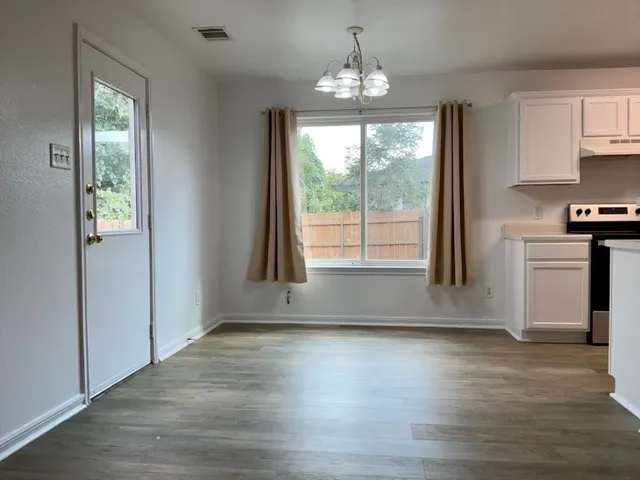 a view of kitchen with granite countertop window and front door