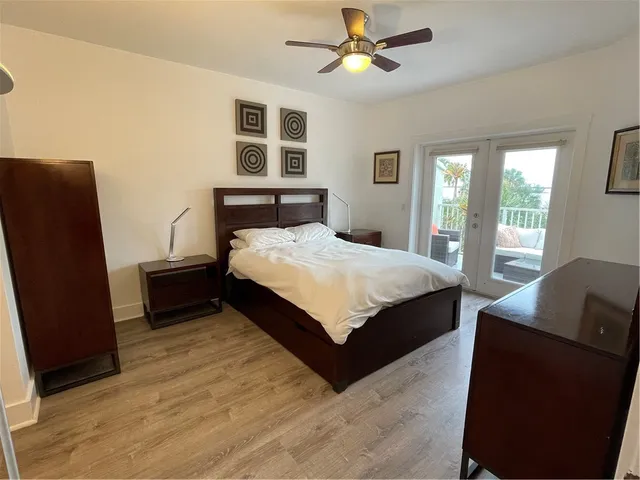 a spacious bedroom with a bed and a dresser