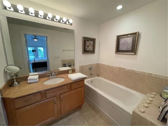 a bathroom with a granite countertop sink a toilet and a shower