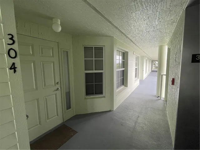 a view of a hallway with wooden shelves