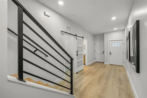 a view of a hallway with hallway with wooden floor