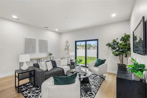 a living room with furniture kitchen and a table