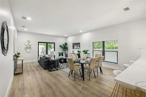 a view of a dining room with furniture and wooden floor