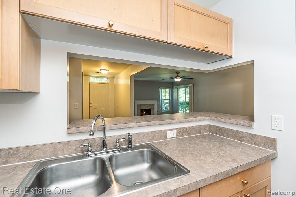 3491 Tremonte Circle Rochester, MI 48306 - Photo 14 of 42 Kitchen with light wood-finish cabinetry and a pass-through window
