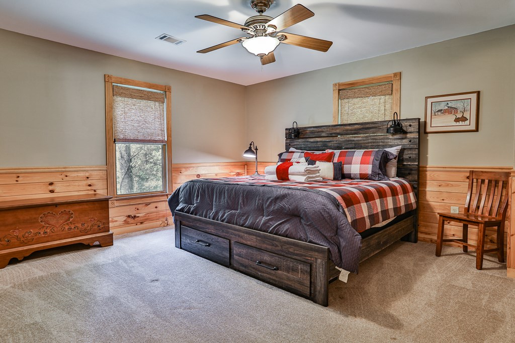 40 Graham Court Ellijay, GA 30540 - Photo 27 of 62 a bedroom with a bed and a chandelier