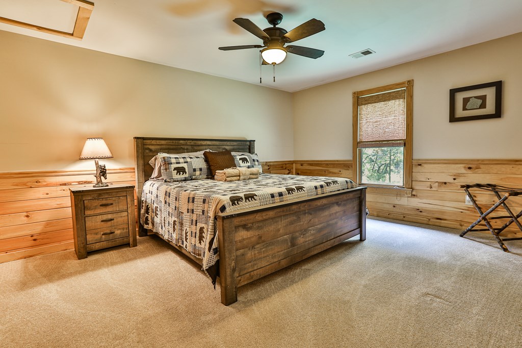 40 Graham Court Ellijay, GA 30540 - Photo 31 of 62 a bed room with a bed and a ceiling fan