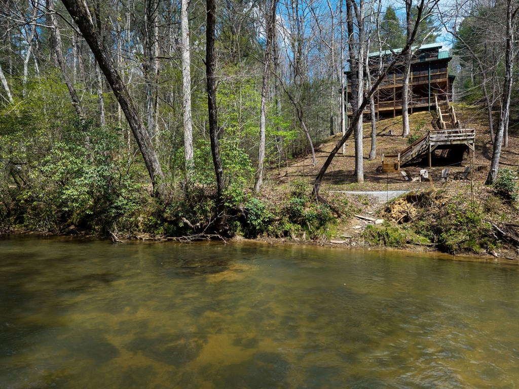 40 Graham Court Ellijay, GA 30540 - Photo 32 of 62 a view of a lake with a house in the background