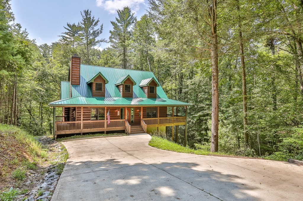40 Graham Court Ellijay, GA 30540 - Photo 4 of 62 a view of a house with a garden and pathway