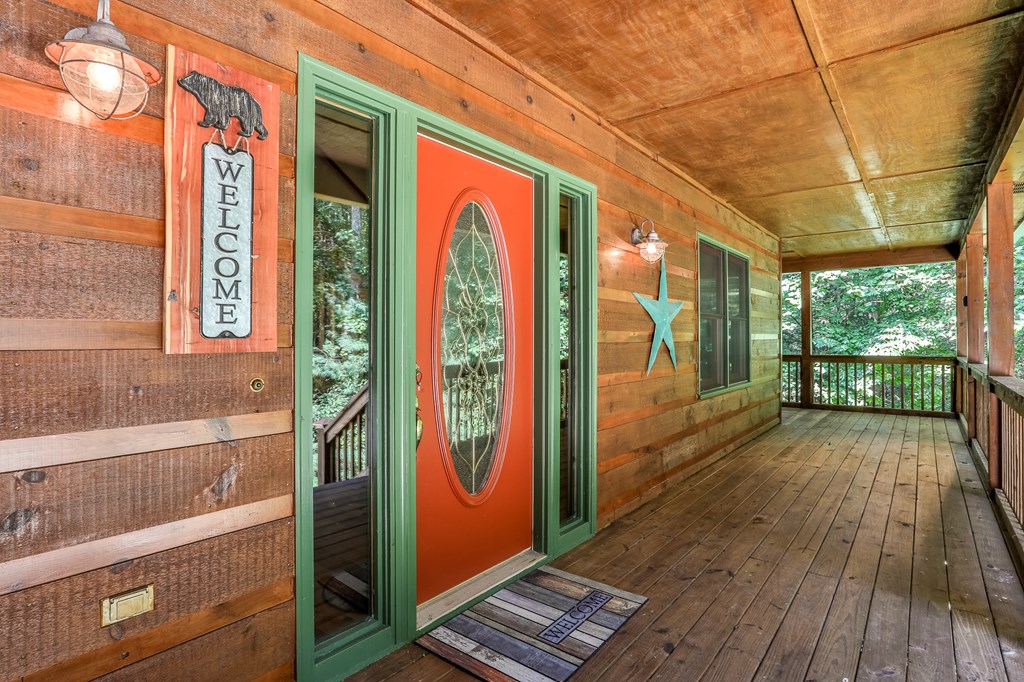 40 Graham Court Ellijay, GA 30540 - Photo 6 of 62 a view of a balcony with wooden floor and iron stairs