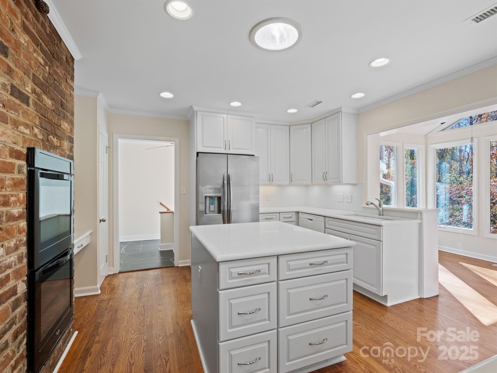 2111 Sagamore Road Charlotte, NC 28209 - Photo 12 of 48 a kitchen with a refrigerator oven and cabinets