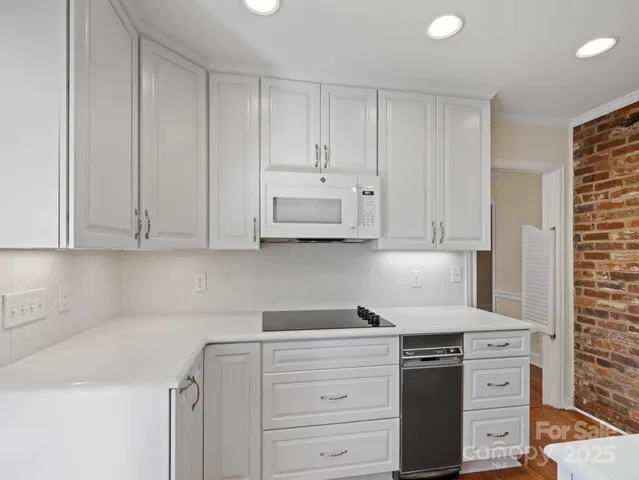 a kitchen with cabinets and stainless steel appliances