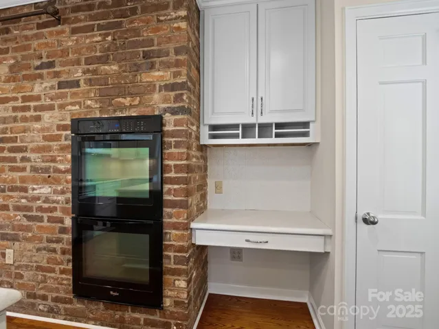a view of an empty room with a window and a ceiling fan