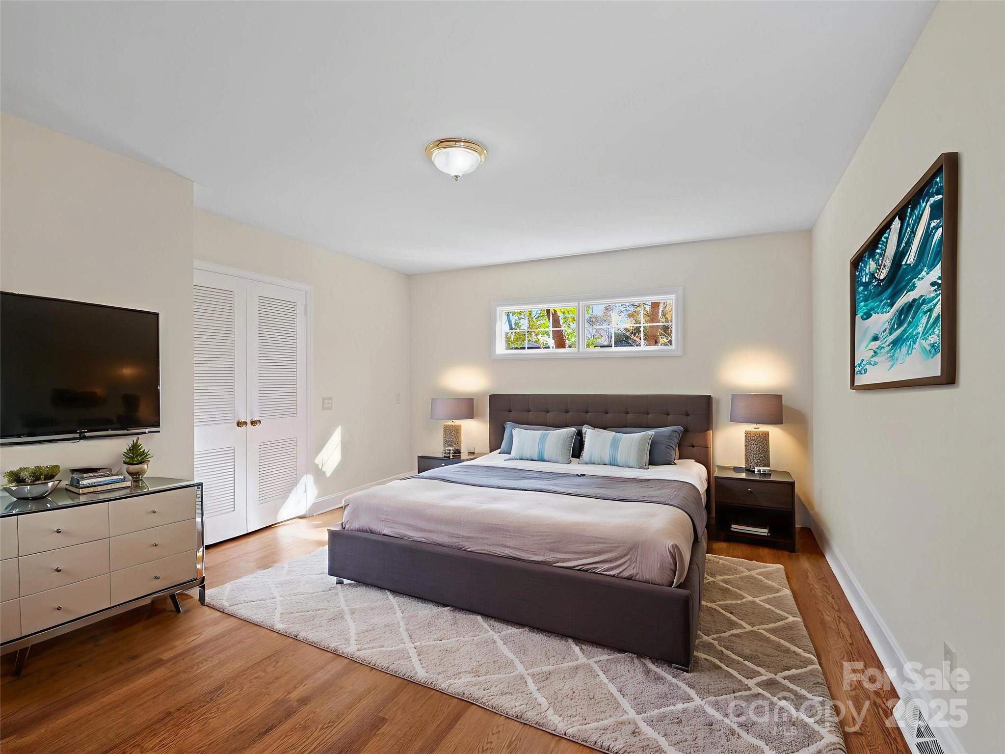 2111 Sagamore Road Charlotte, NC 28209 - Photo 20 of 48 a bedroom with a bed and a flat screen tv