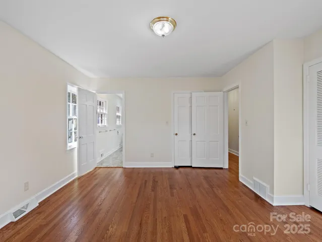 a bathroom with double vanity and a mirror